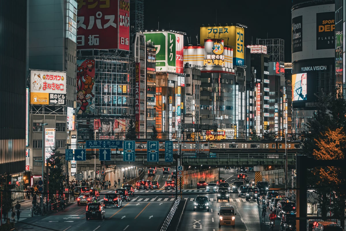 Shinjuku at night, neon signs and skyscrapers over a busy street