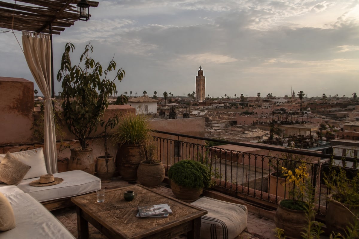 A riad rooftop terrace overlooking the Marrakech medina, no faces