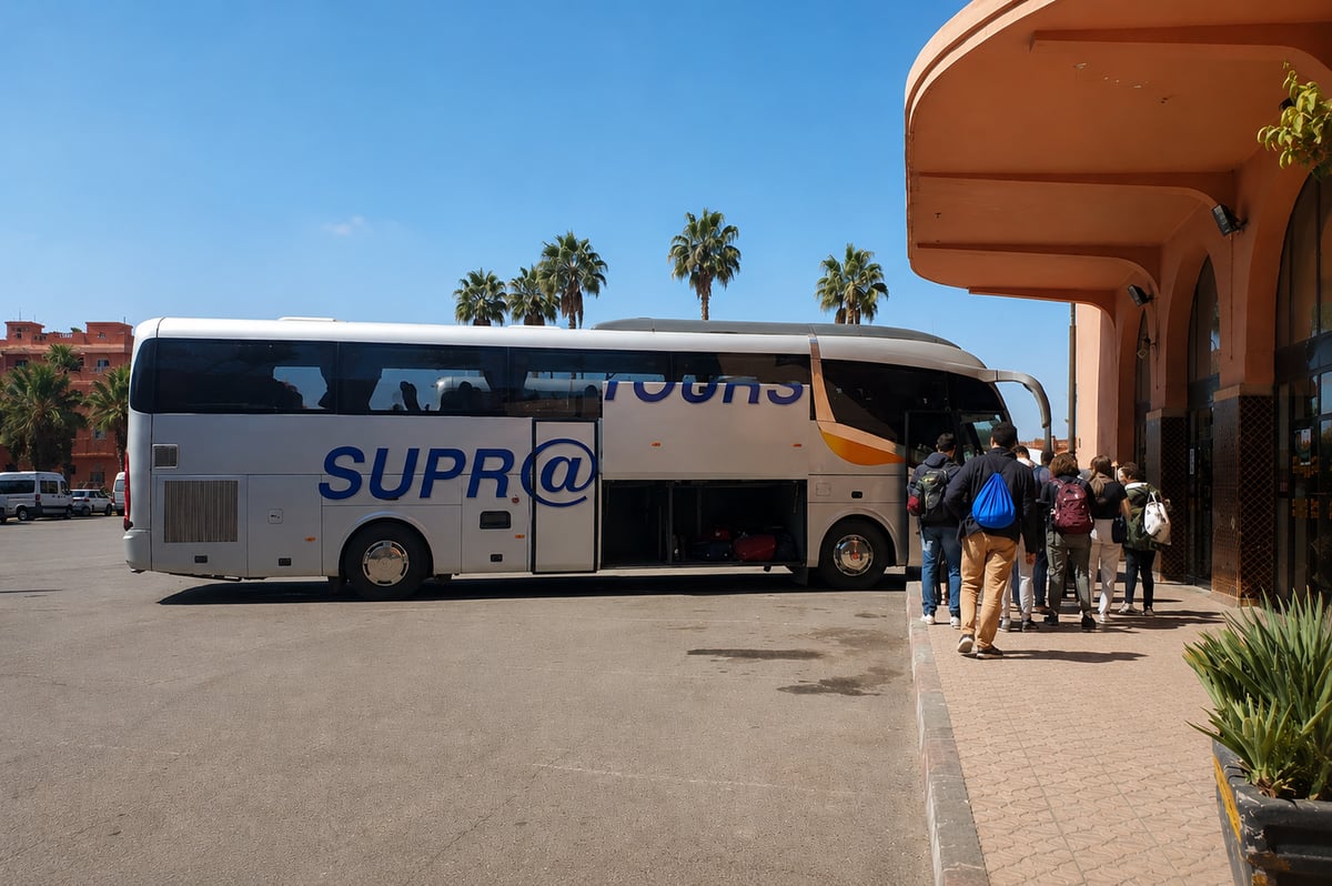 A modern intercity coach at a Moroccan bus station, no clear faces