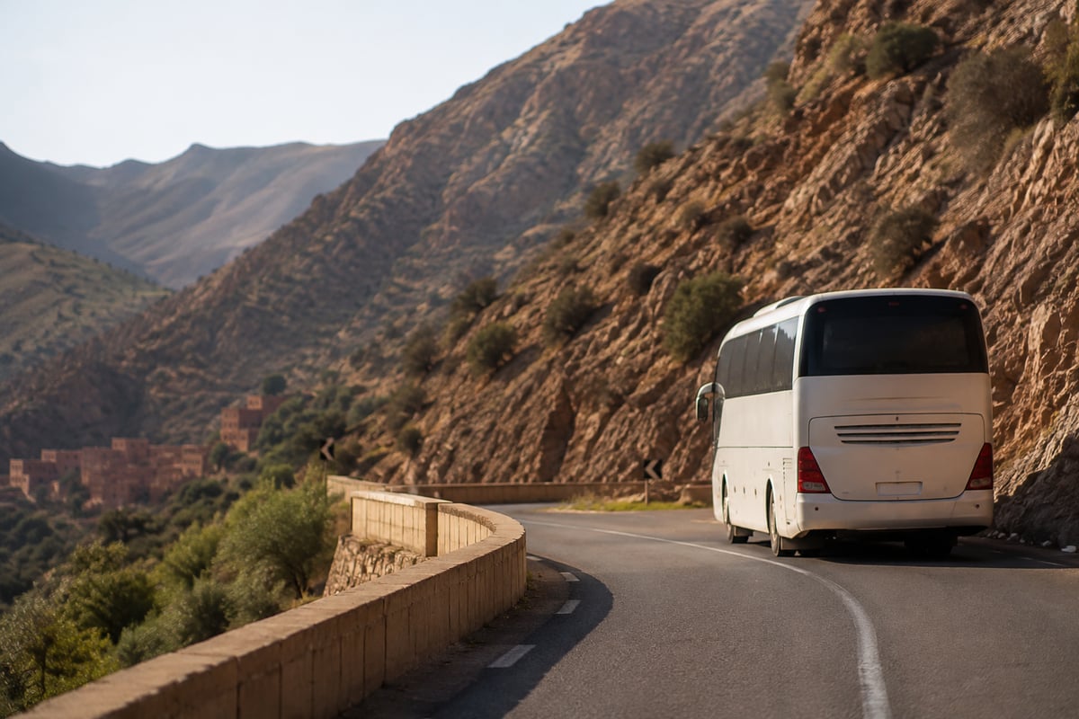 A coach travelling a scenic Moroccan mountain road, no clear faces