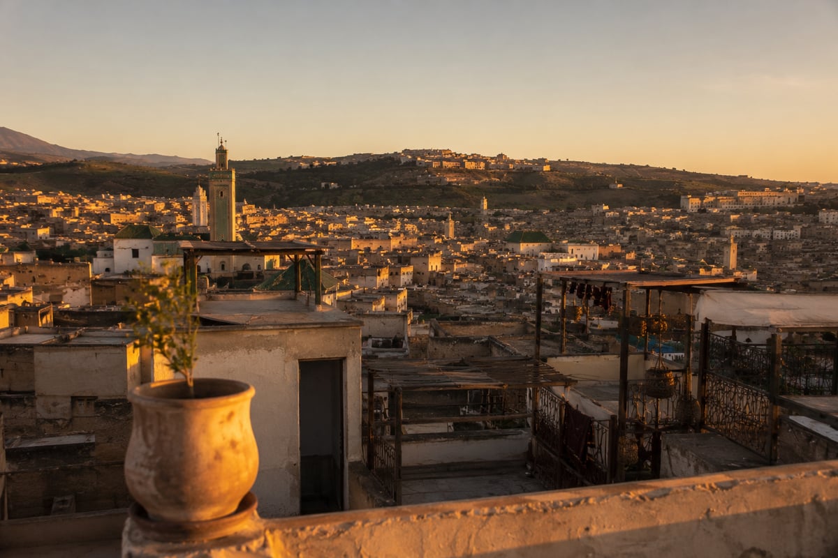A rooftop view over the Fez medina at golden hour, no faces