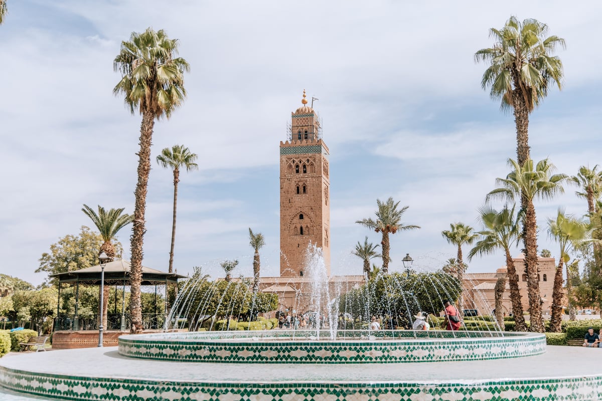 A Marrakech garden or square in pleasant spring light, no clear faces
