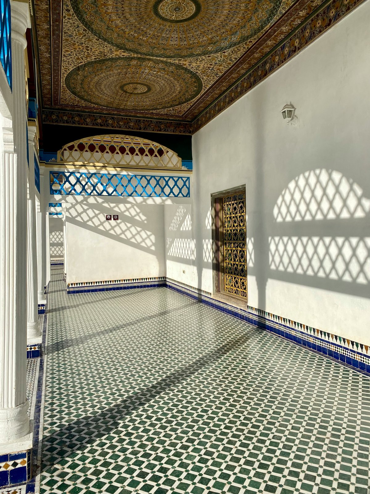 The ornate tilework and courtyard of the Bahia Palace, no clear faces