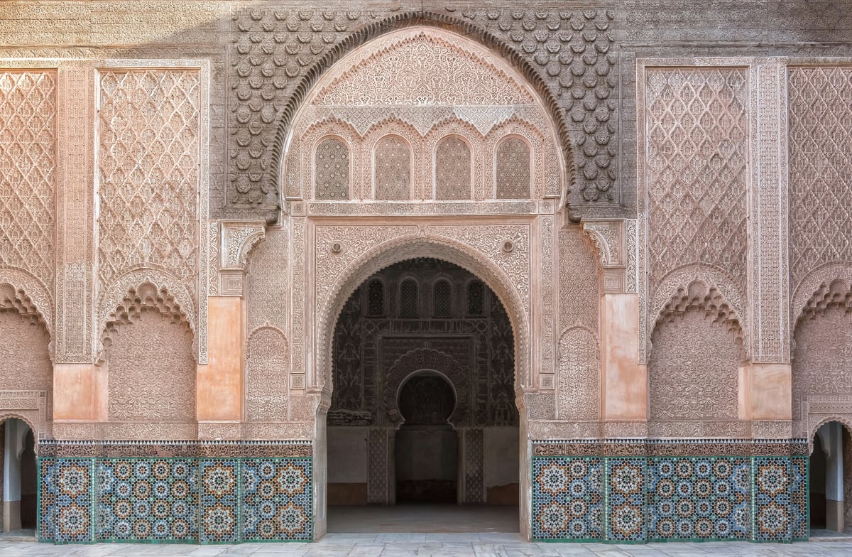 The courtyard of the Ben Youssef Madrasa with carved detail, no clear faces