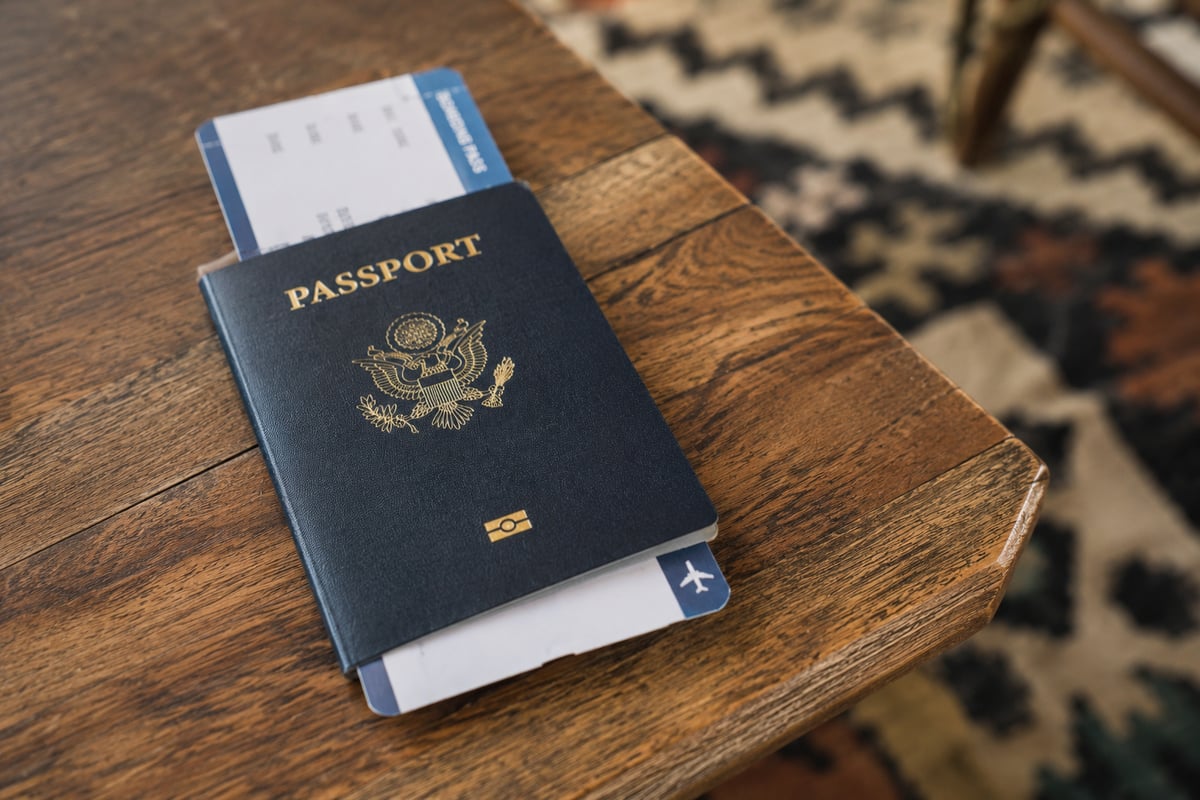 A US passport and boarding pass on a table, no personal details visible