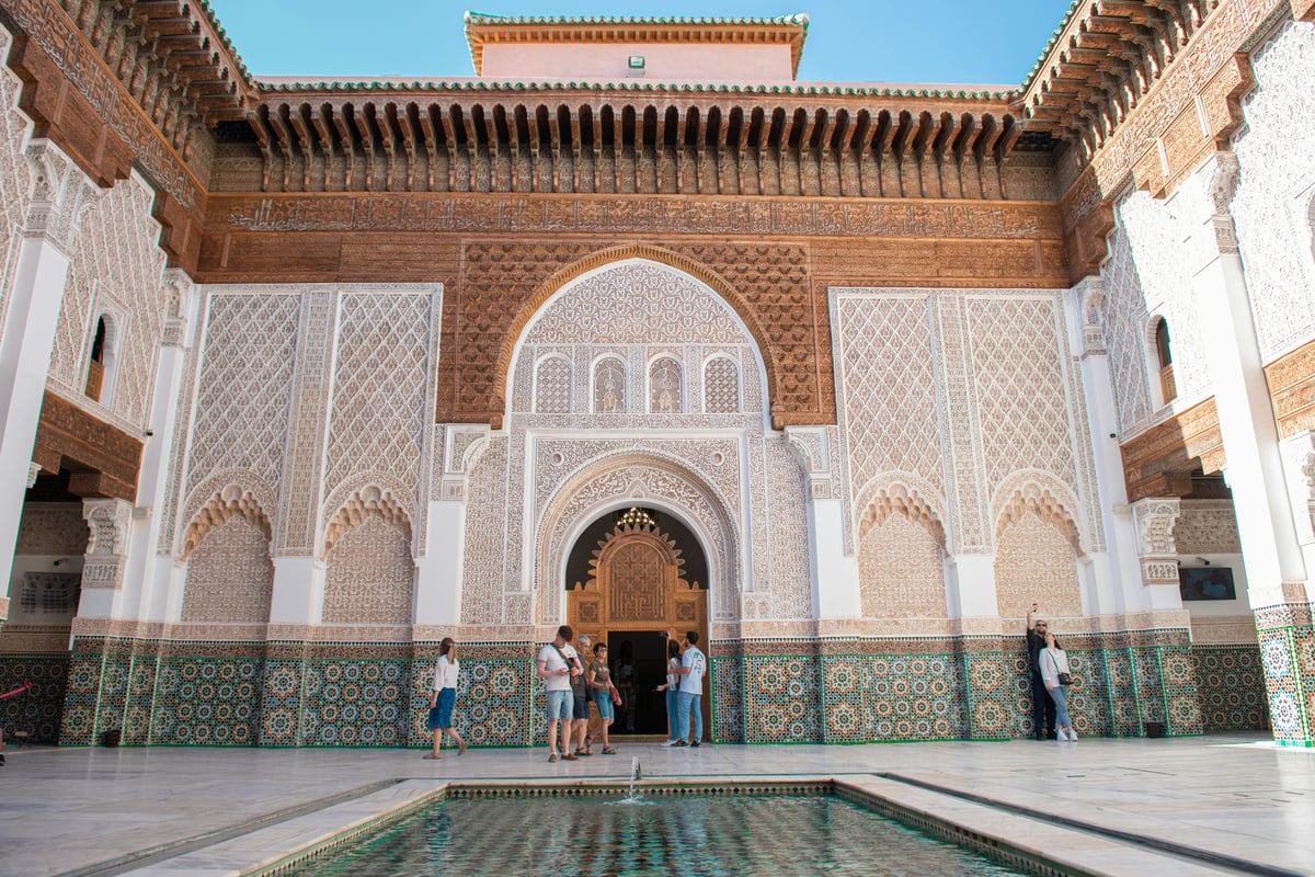 An ornate madrasa courtyard with tilework in Morocco, no faces