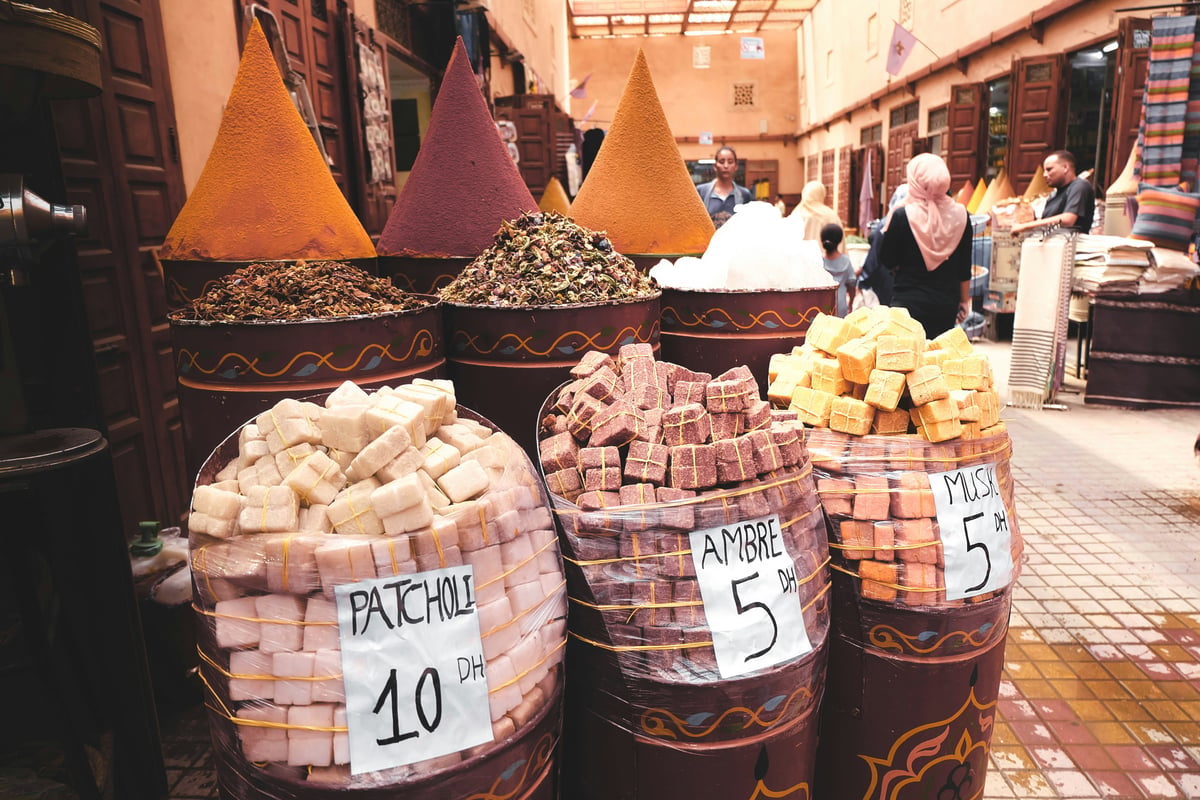 A market stall in a Moroccan souk with produce and price tags, no faces