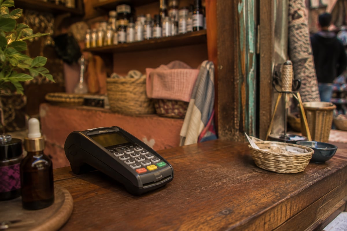 A card terminal on a shop counter in Morocco, no faces or readable numbers