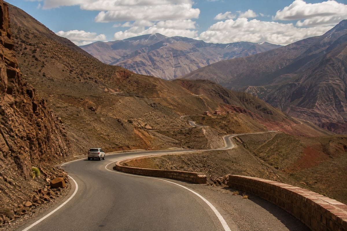 A winding mountain road in the Atlas with a car in the distance, no faces