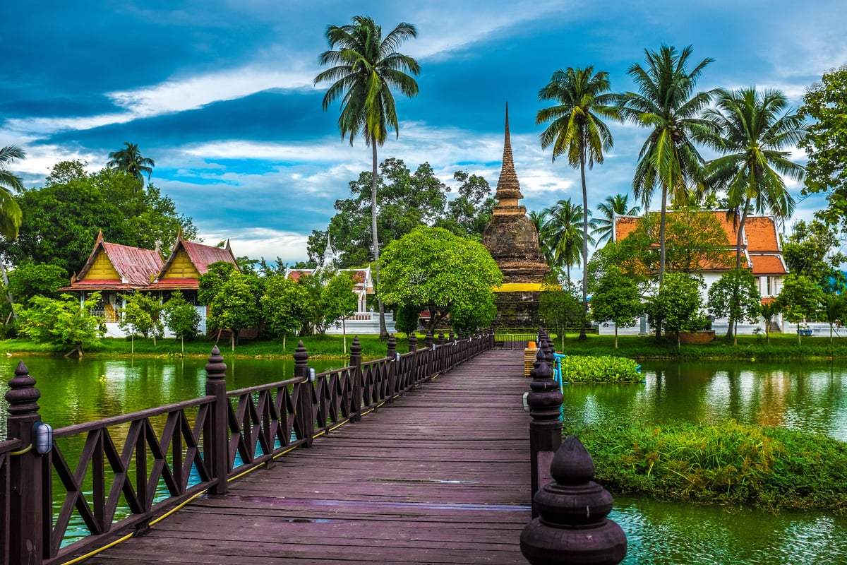 A sweeping, aspirational Thailand montage — temple, mountain, and island