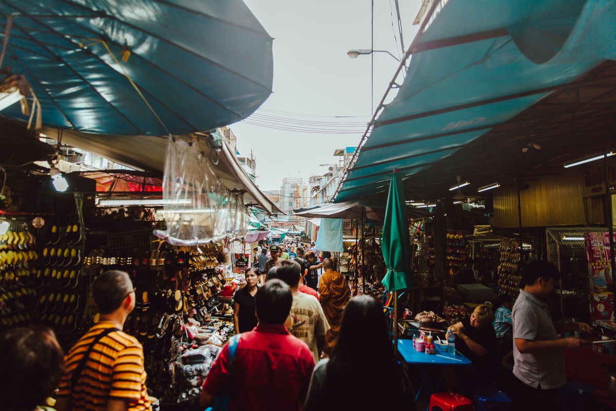 A bustling, colorful Bangkok market scene