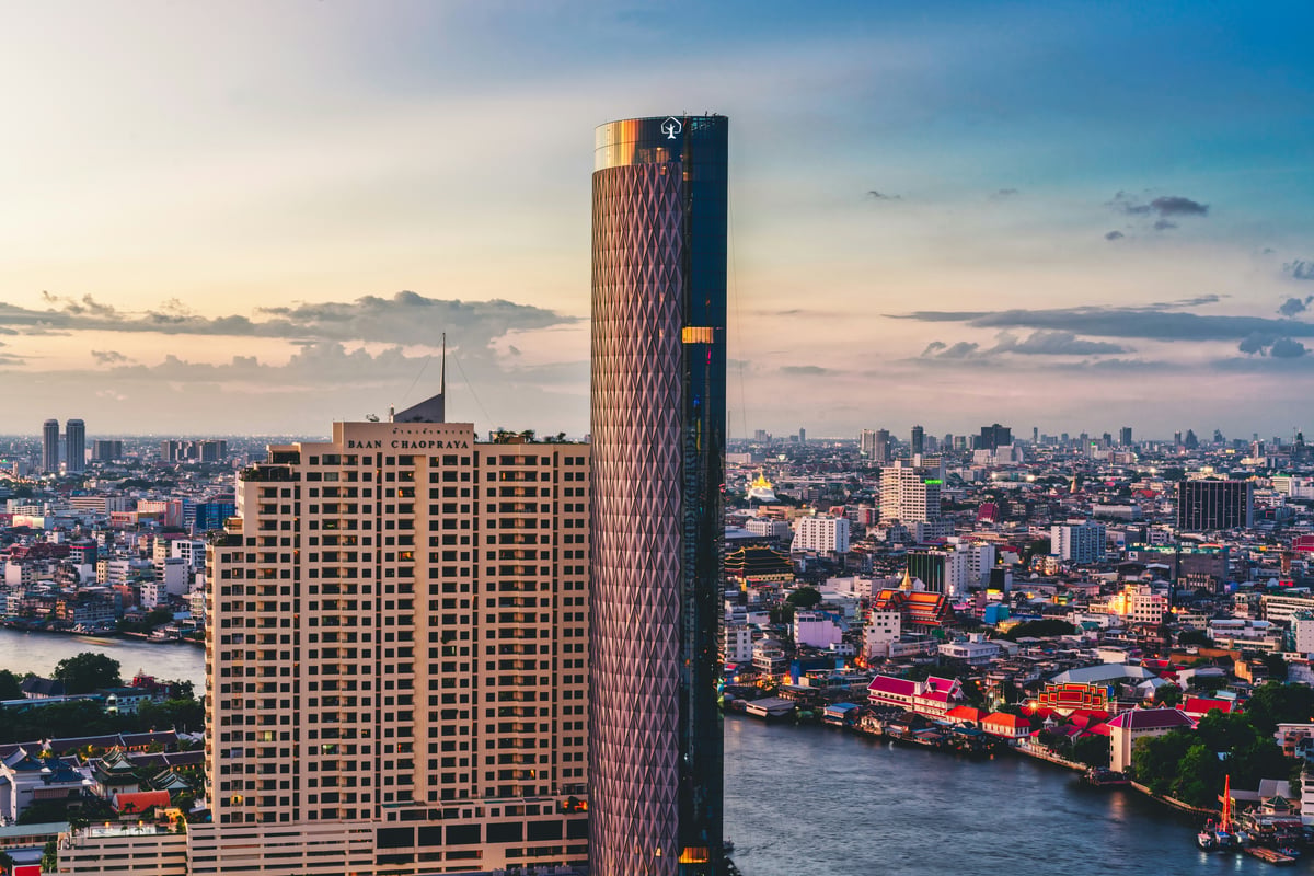 A riverside Bangkok hotel pool overlooking the Chao Phraya River and temples