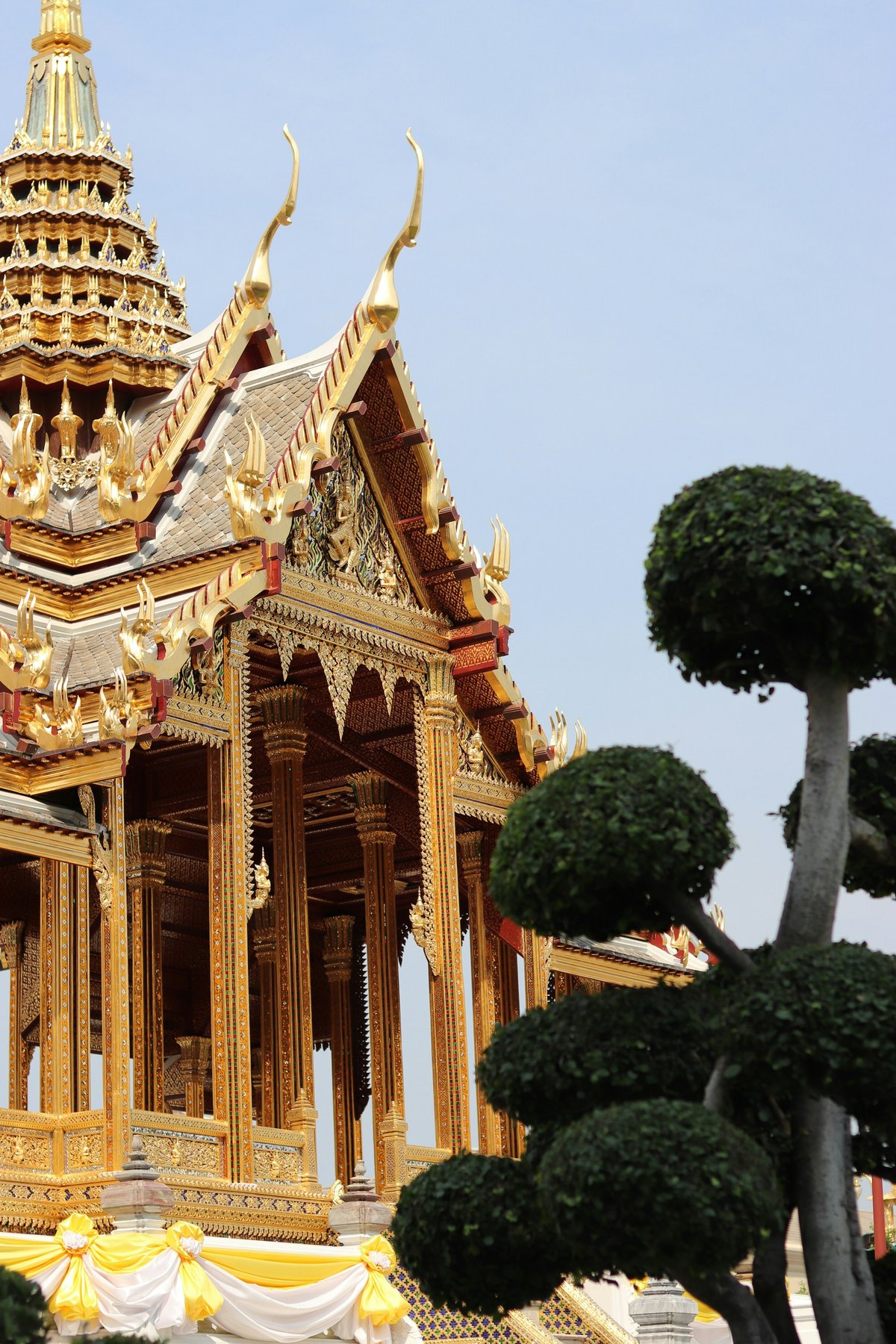 A spectacular golden Thai temple against a blue sky