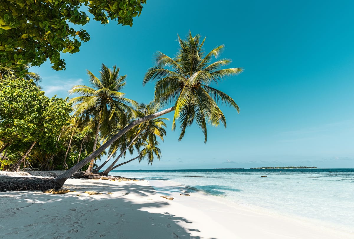 A sunny Thai beach or temple under clear blue skies
