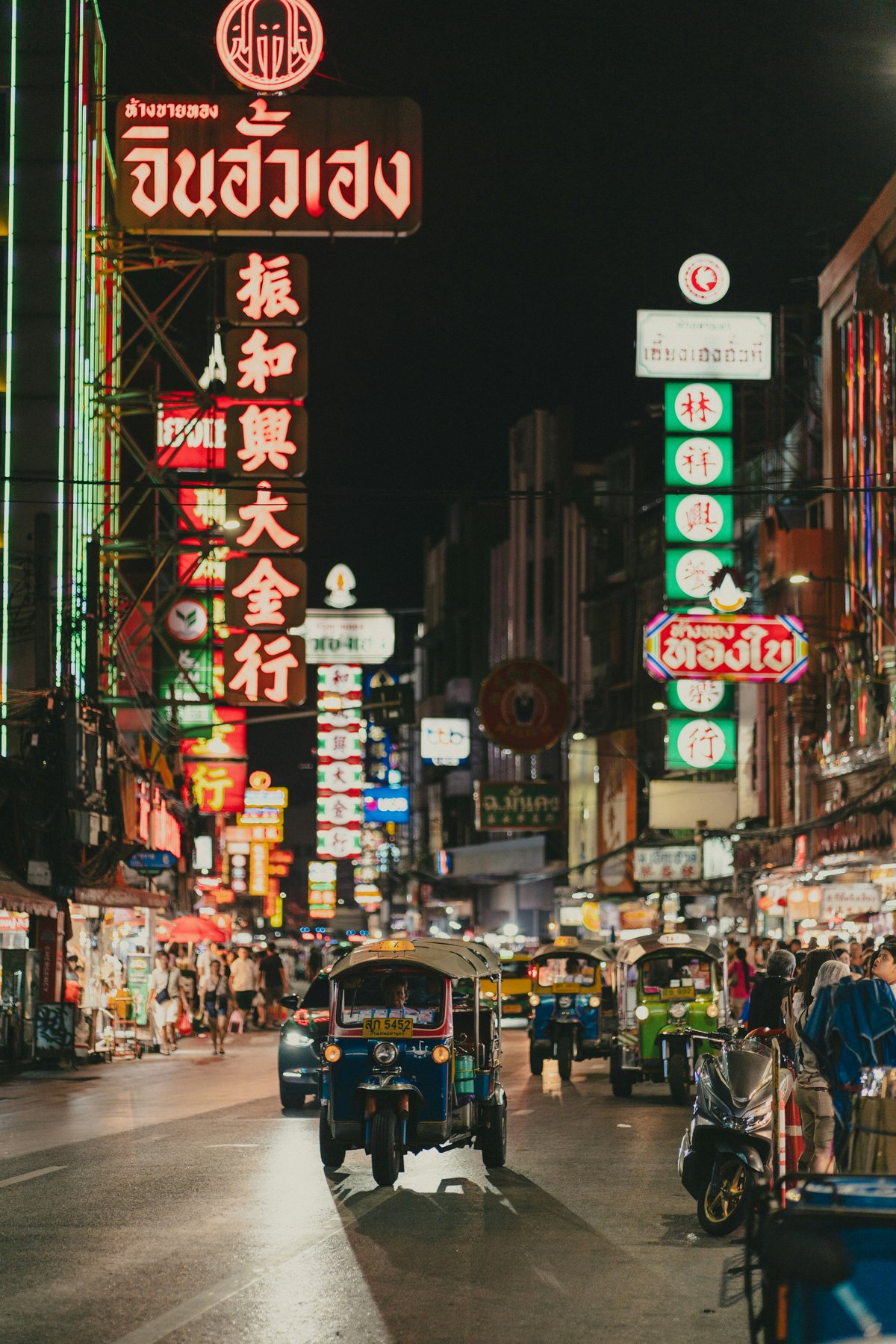 A busy Bangkok tourist street with tuk-tuks