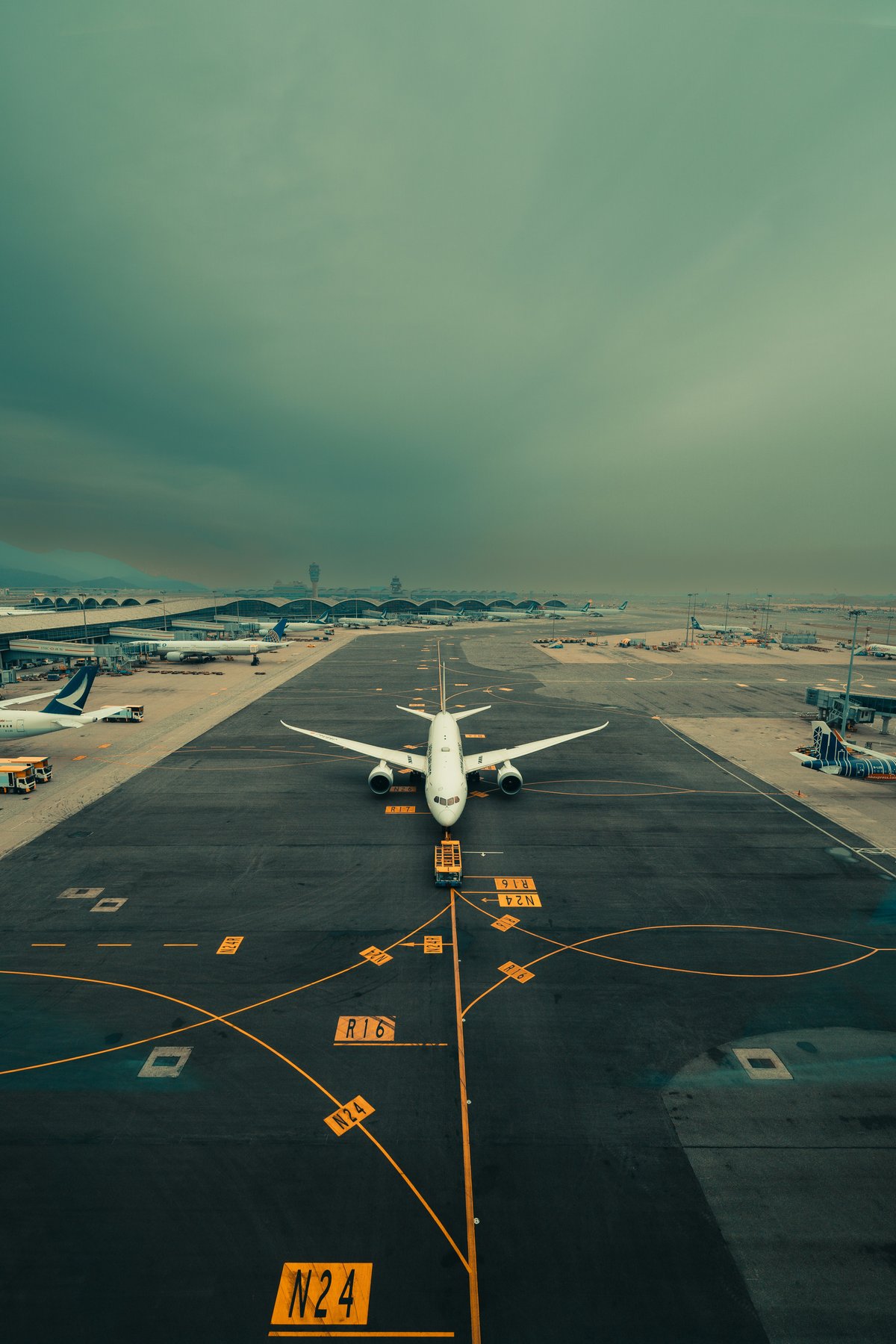 A plane on the tarmac or wing-over-islands view, bright and travel-y
