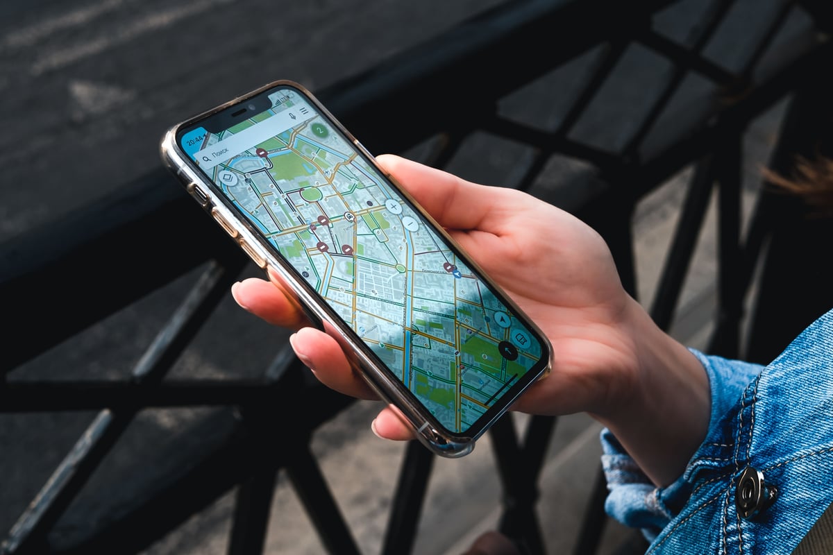 A smartphone showing a ride-hailing map in a Thai city