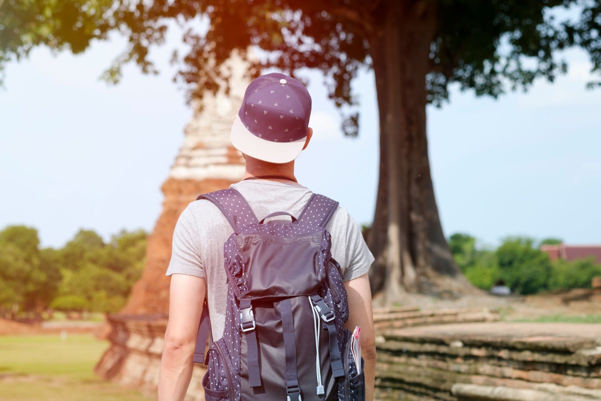 A traveler looking out over a Thai landscape, planning feel