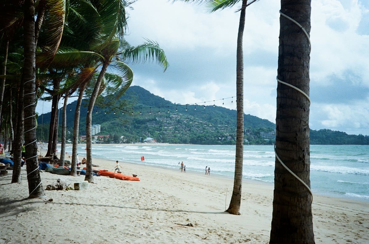 Railay's longtail boats and cliffs vs a lively Phuket beach scene