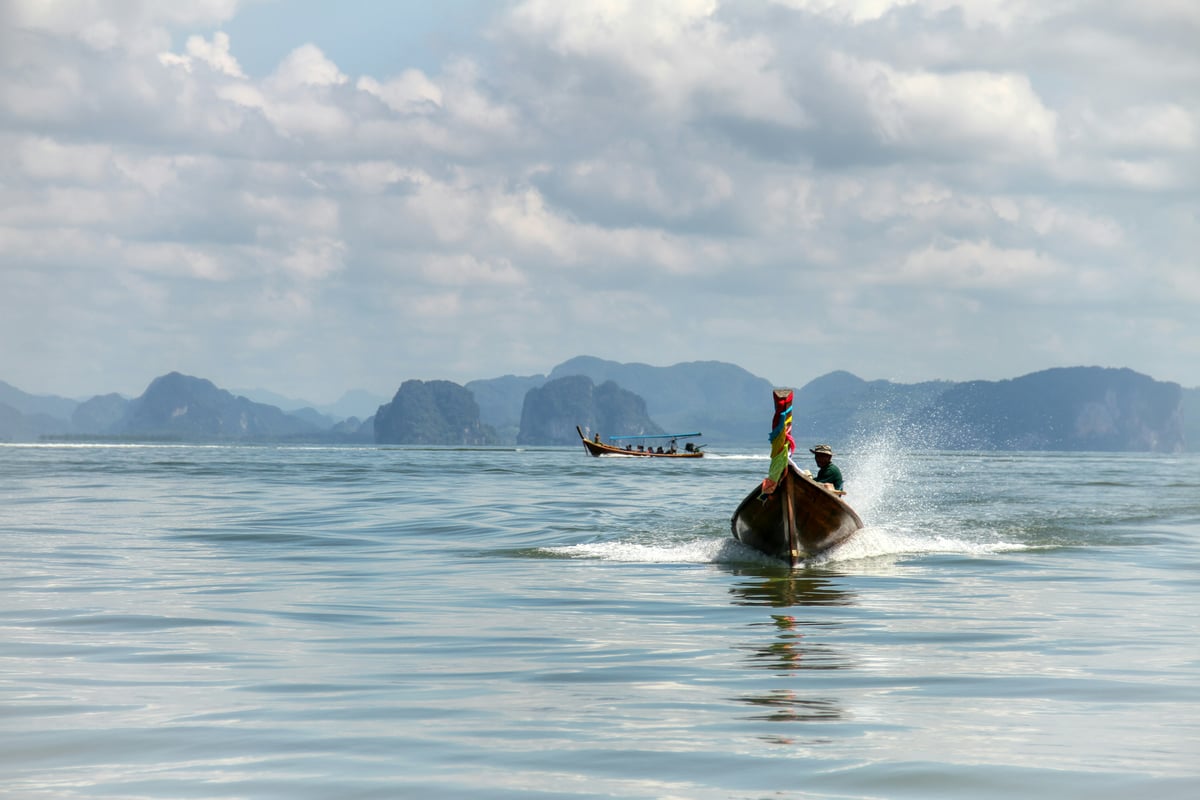 A longtail boat among the limestone karsts of Phang Nga Bay
