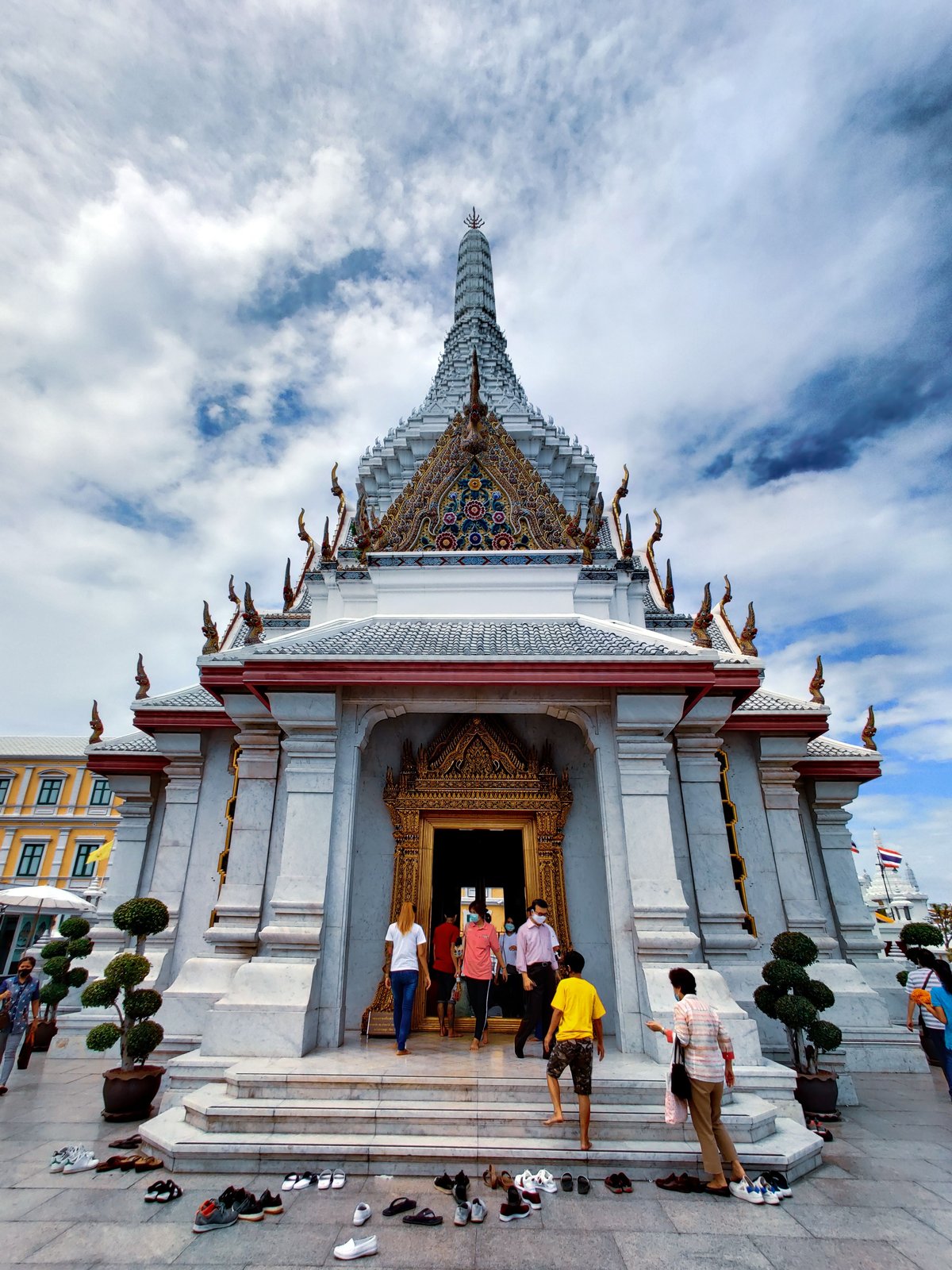 People removing shoes outside a temple or home