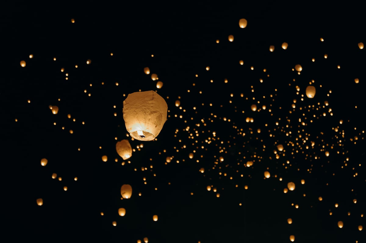 A vibrant Thai festival scene — lanterns, water, or a colorful procession
