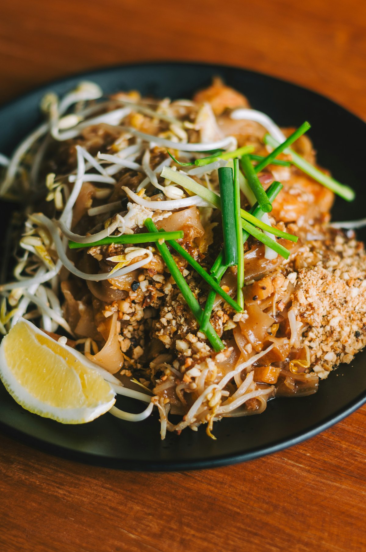 A plate of fresh Thai street food being handed over