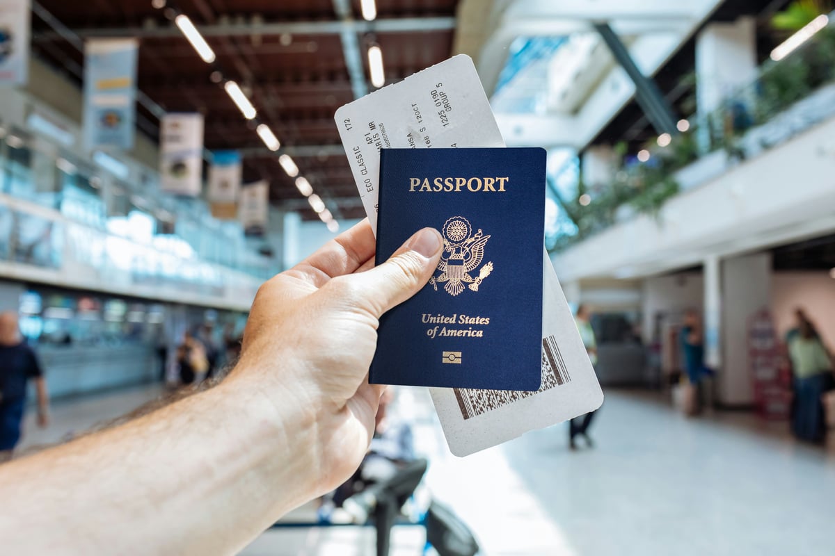 Travel documents — passport, boarding pass, phone — laid out