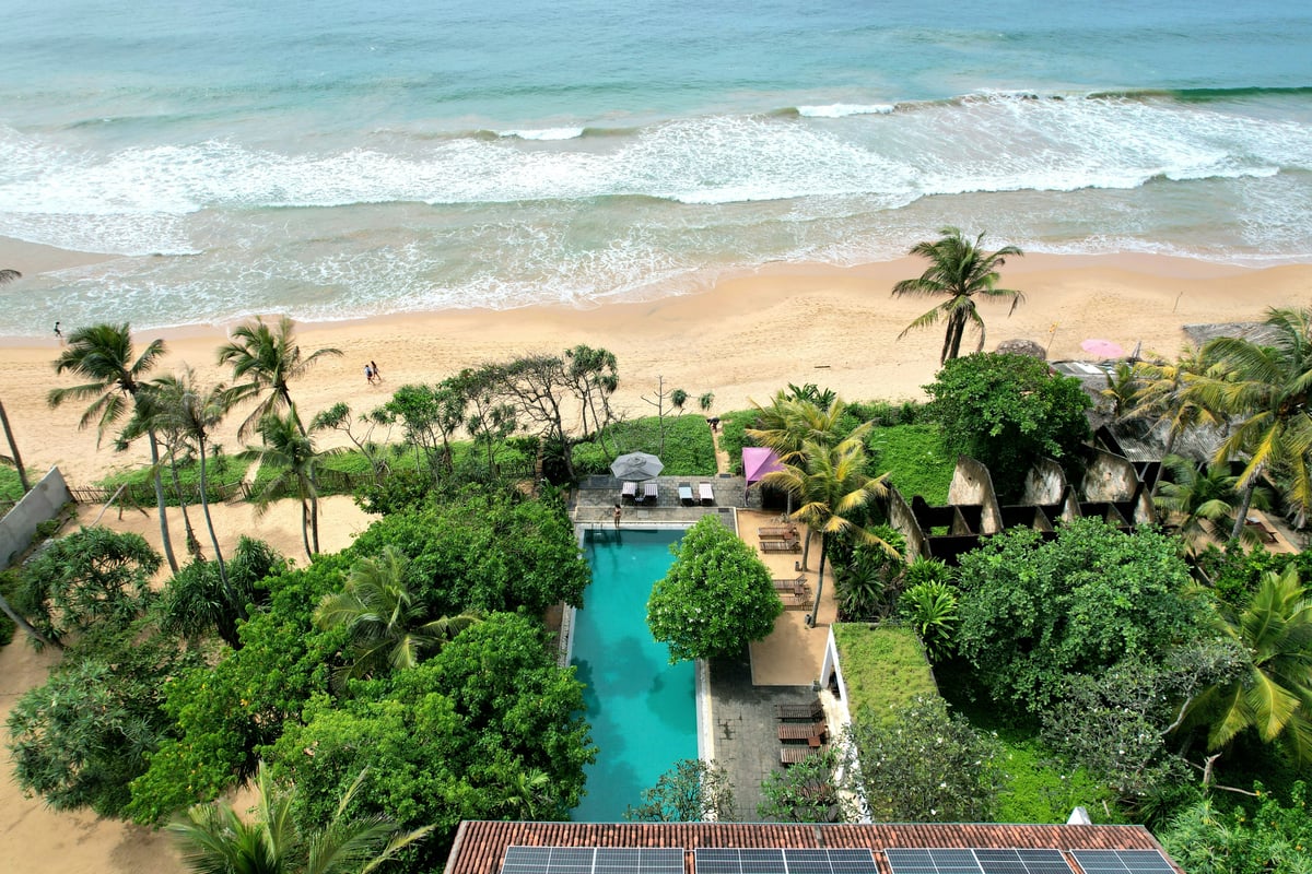 A romantic beachfront villa or infinity pool at sunset in Thailand