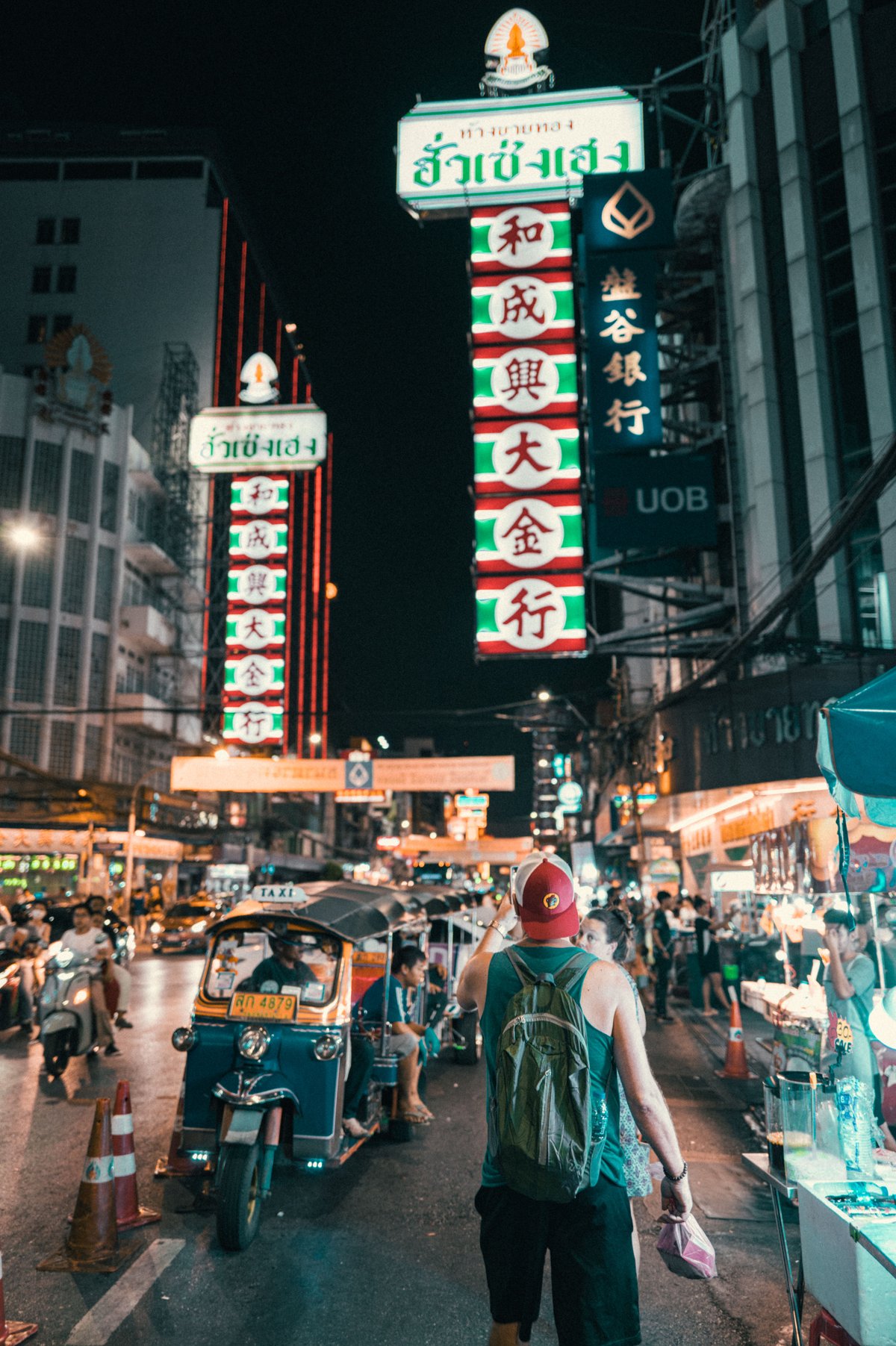 A budget traveler enjoying a Thai street food market