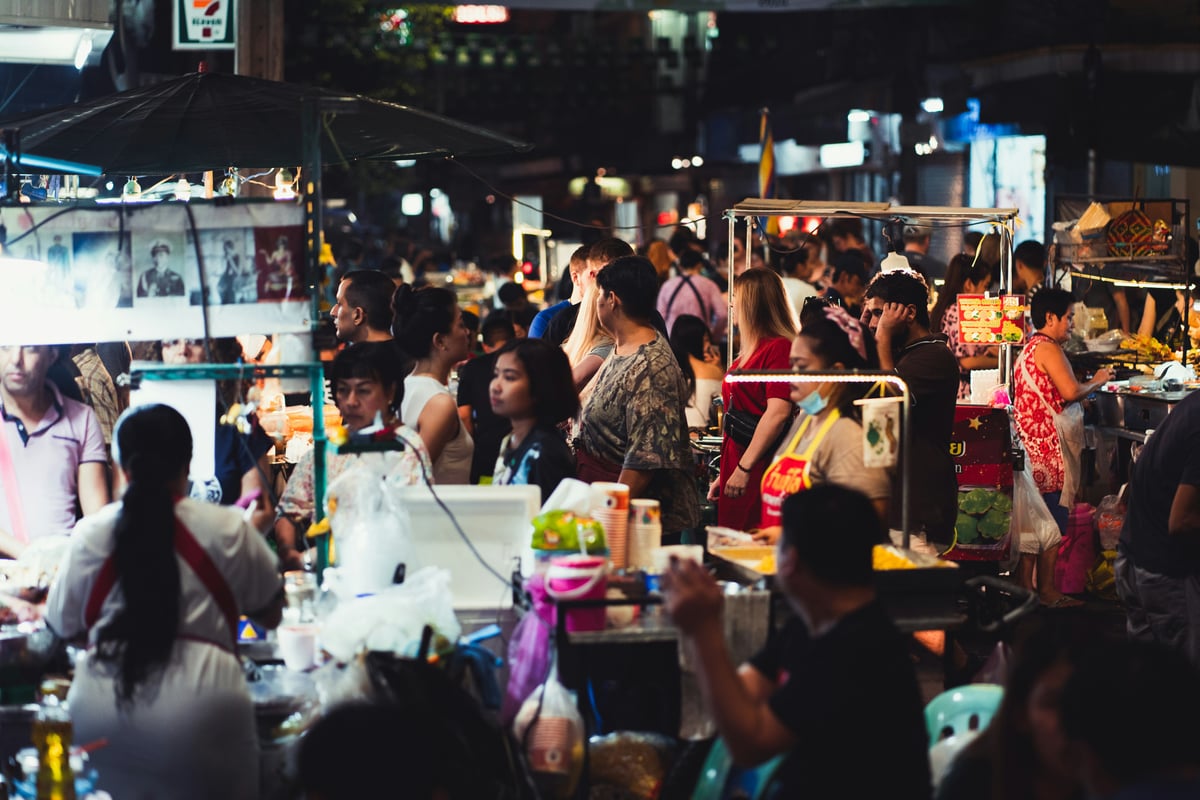 A clean, busy Thai street food stall cooking fresh food