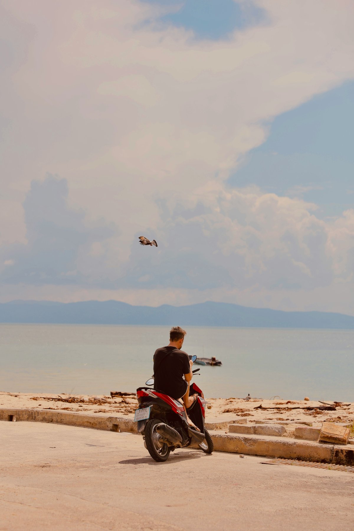A scooter parked on a Thai island road — the classic risk image