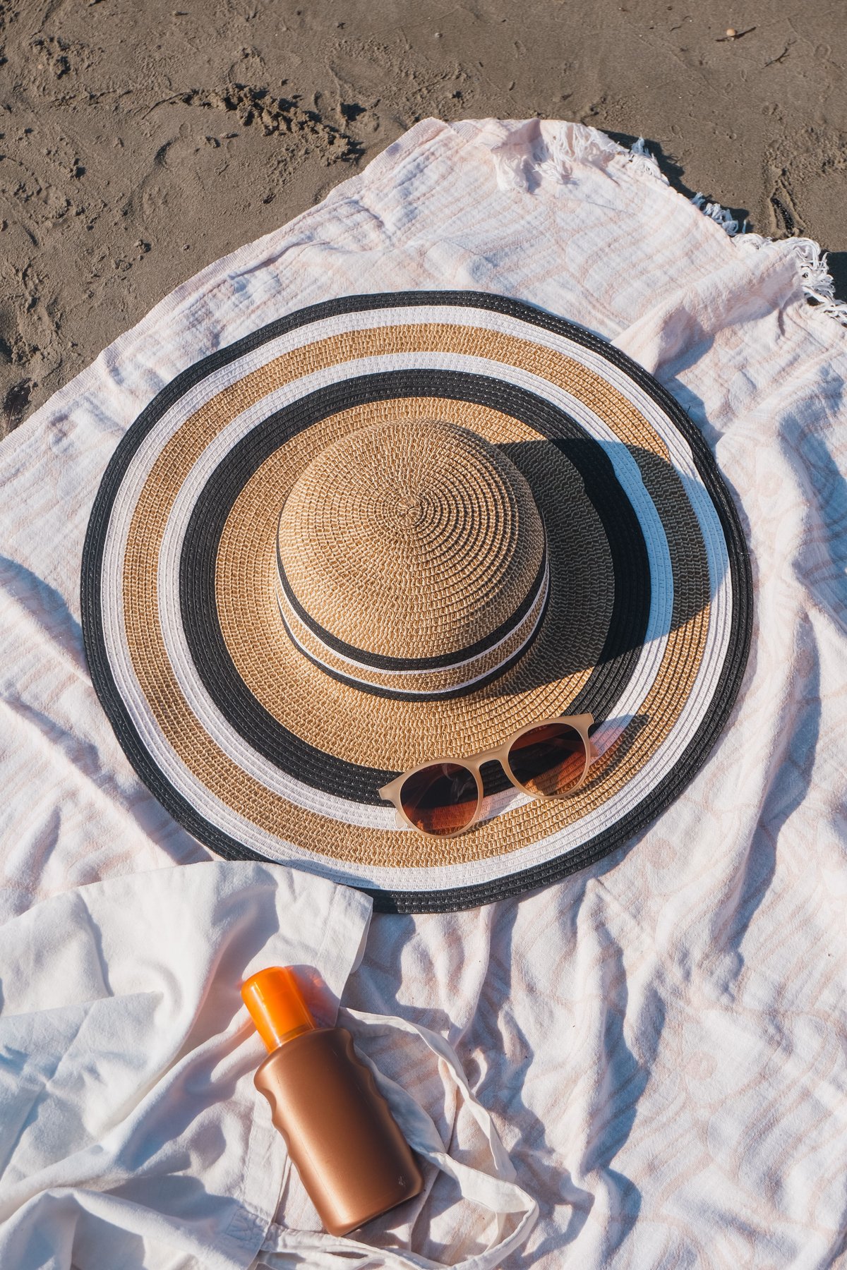 Travel essentials — sunscreen, hat, repellent, reusable water bottle