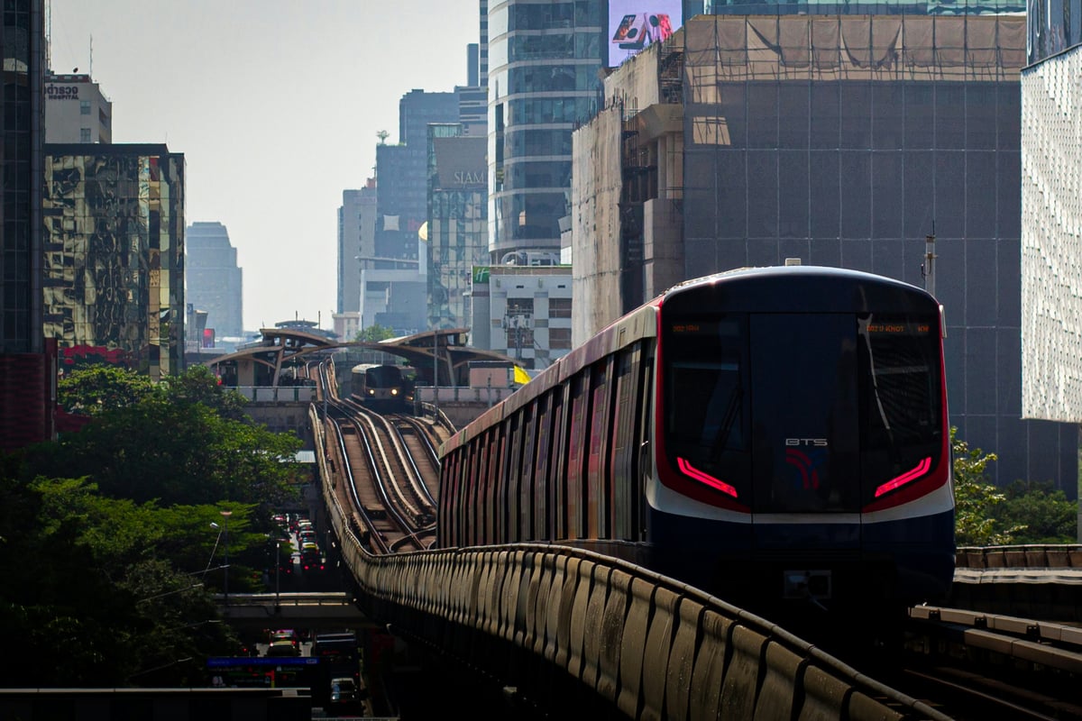 The BTS Skytrain gliding past Bangkok high-rises at golden hour