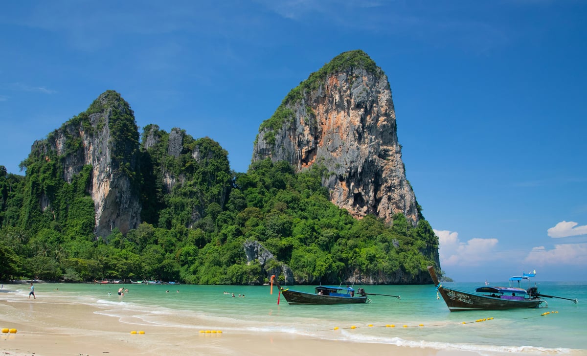 Krabi's limestone karsts rising from turquoise water with longtail boats