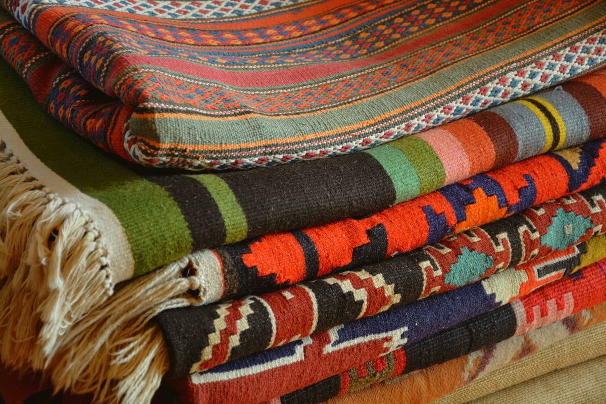 a single kilim laid flat showing pattern and weave, overhead, no hands, no shop context