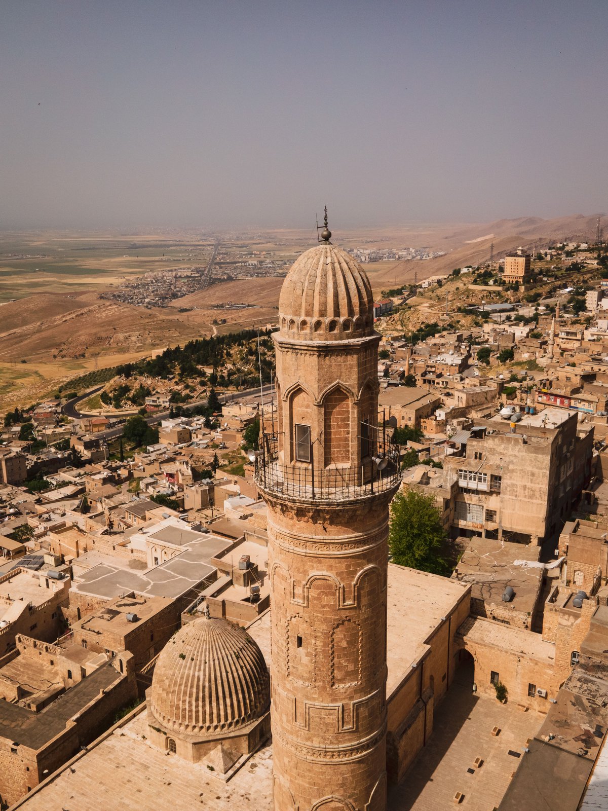 A dramatic Eastern Turkey landscape — mountains or a historic site at golden hour, no recognizable faces