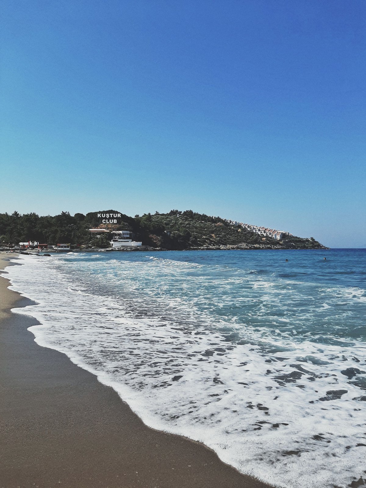 Pigeon Island fortress connected by causeway at Kusadasi, blue Aegean water