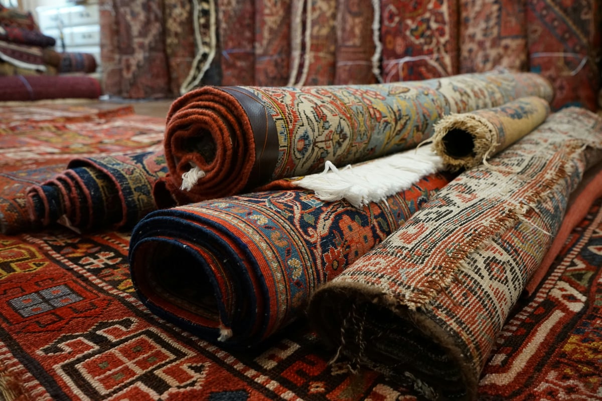 old kilims and textiles folded in stacks in a Turkish shop, objects only, no people