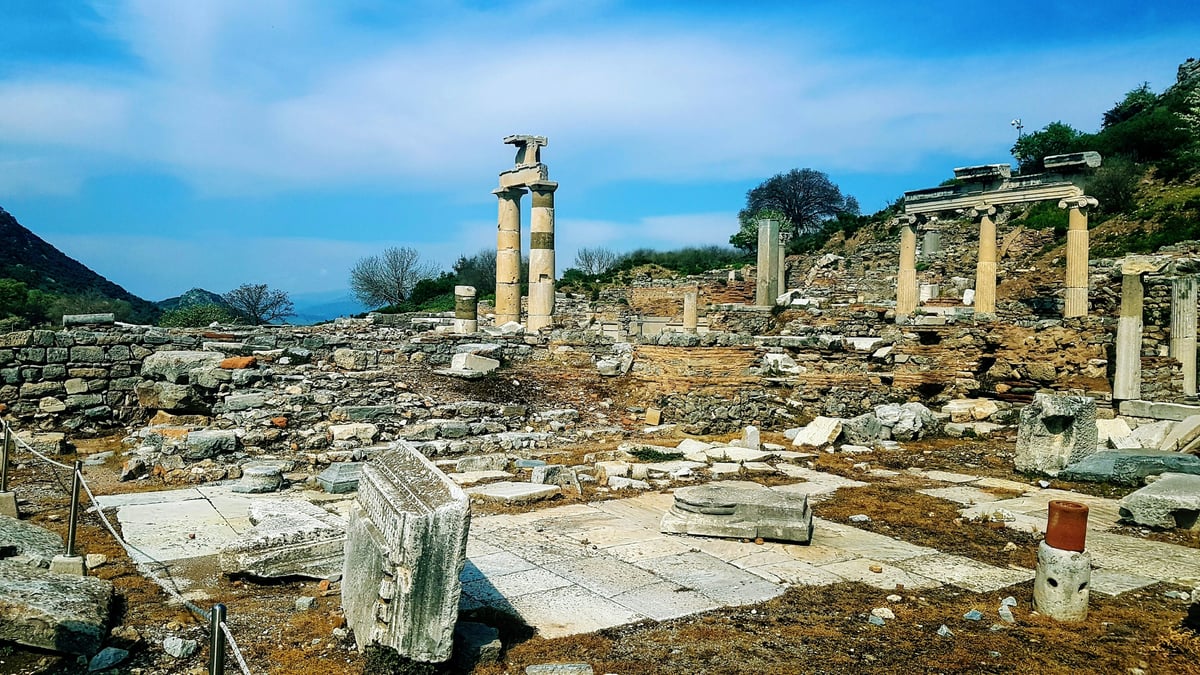 scattered ancient stone fragments on the ground at a Turkish archaeological site, no hands, no people