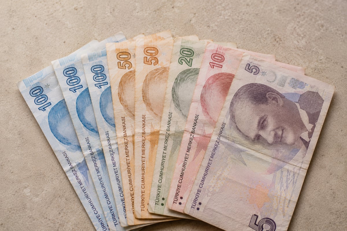 Turkish lira banknotes fanned on a plain surface, currency only, no hands, no faces