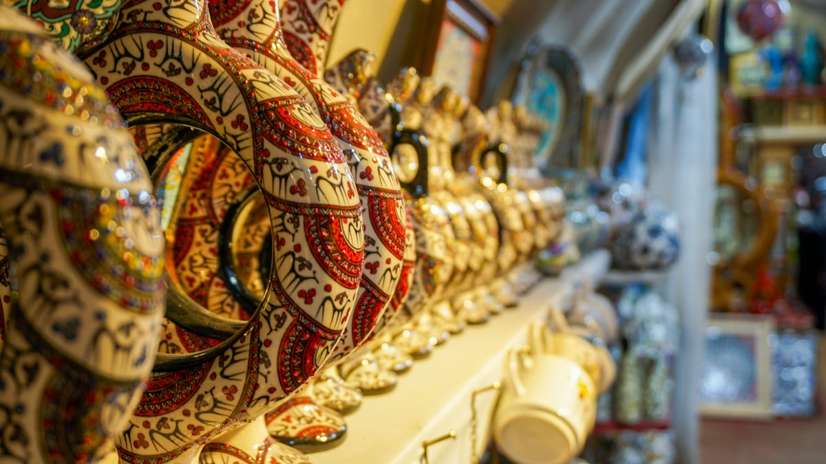 an ordinary Turkish souvenir stall of new ceramics, evil-eye glass and textiles, objects only, no people