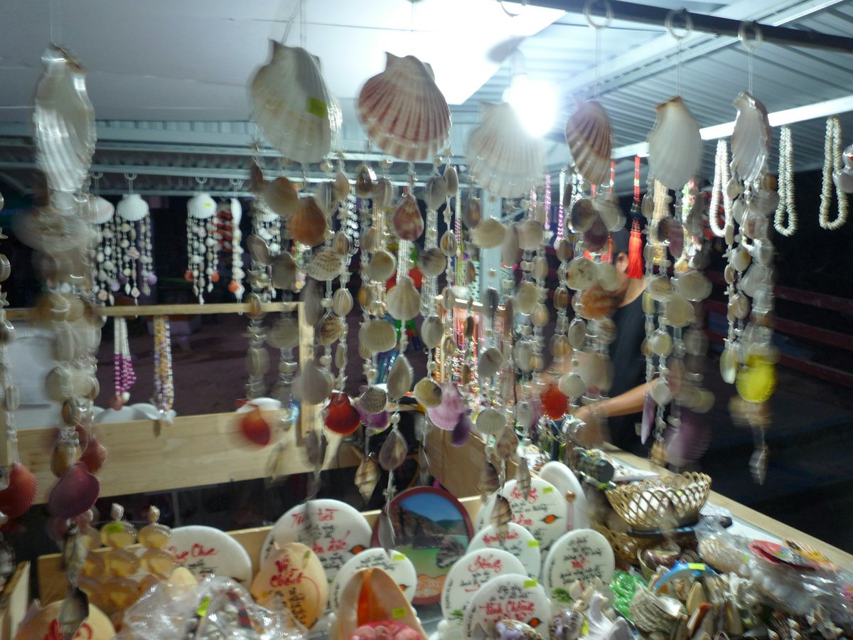 Souvenir stall hung with shell mobiles and painted ceramics