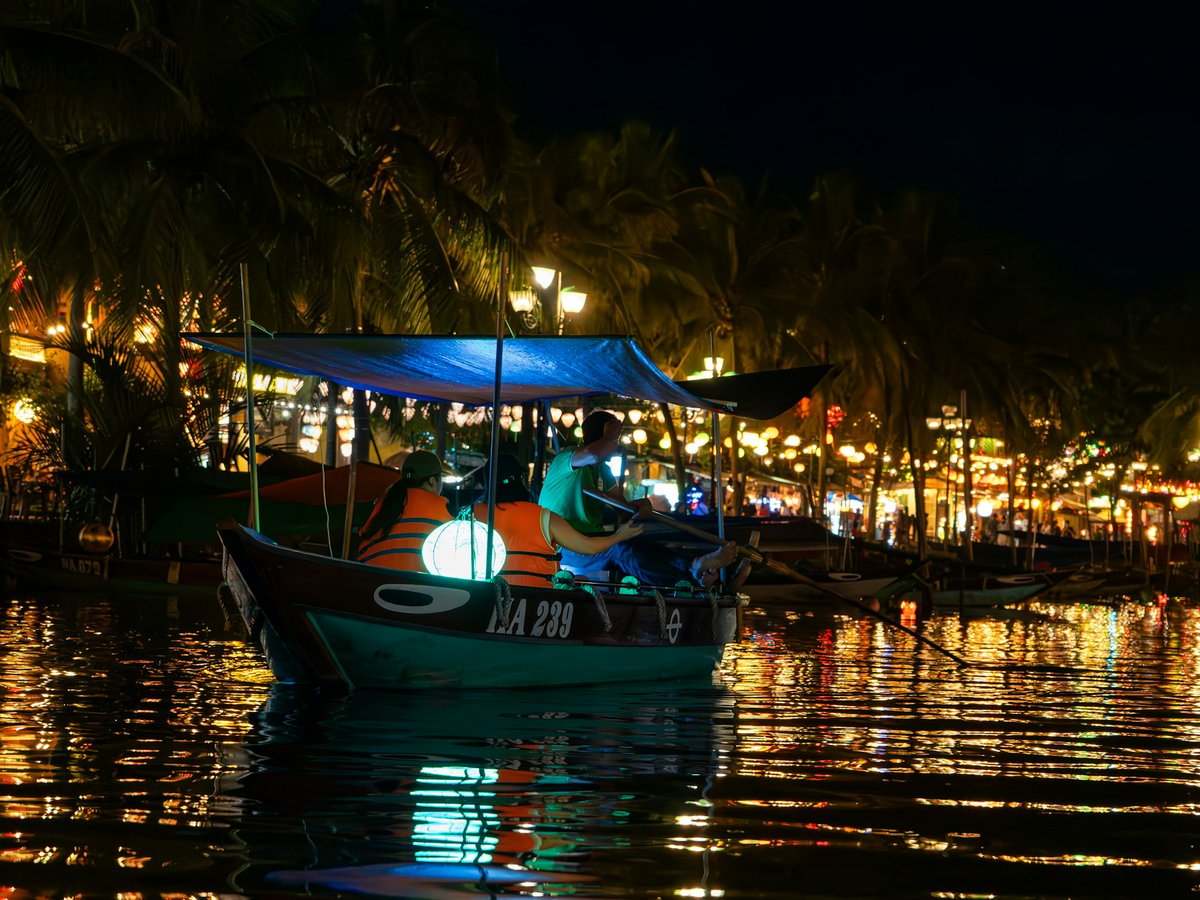 A lantern-lit boat on the Thu Bon river at Hoi An after dark