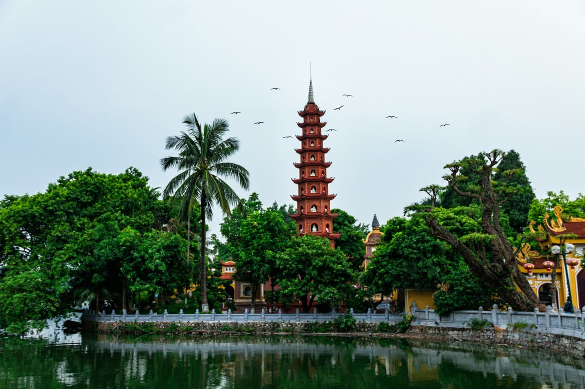 Tran Quoc Pagoda rising above the trees beside West Lake in Hanoi