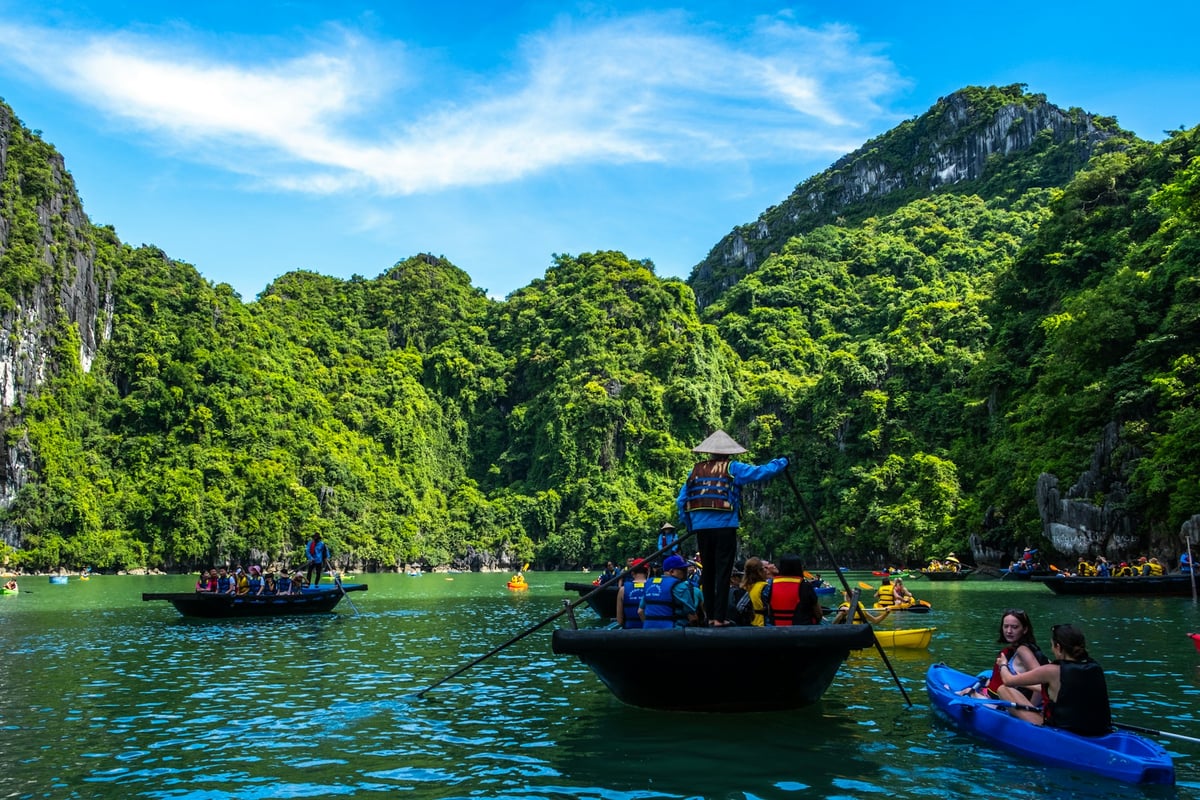 Small boats and kayaks among the limestone karsts of the bay