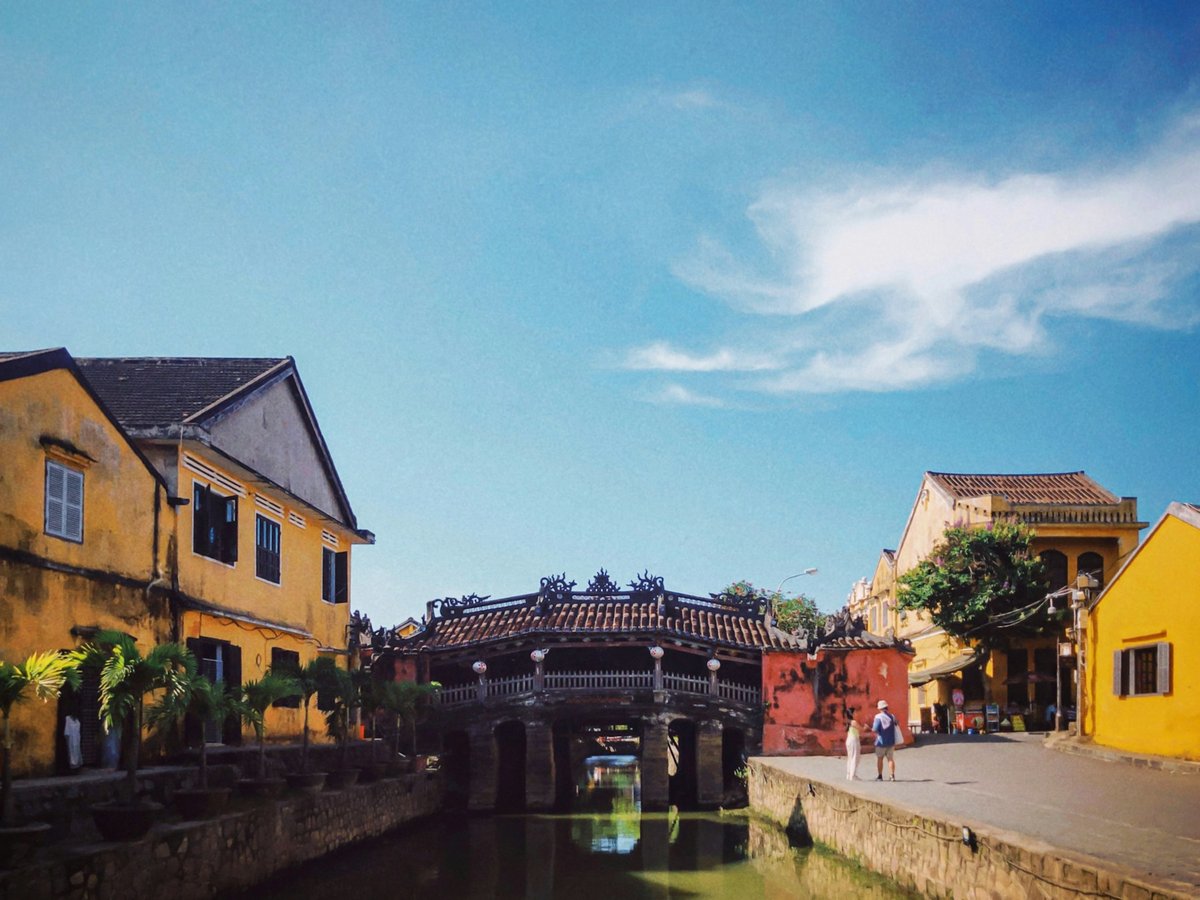 The Japanese Covered Bridge in Hoi An between yellow-walled buildings