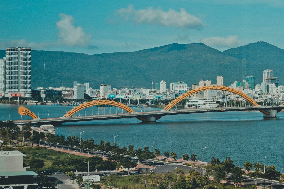The Han River bridges and the Da Nang skyline below forested hills