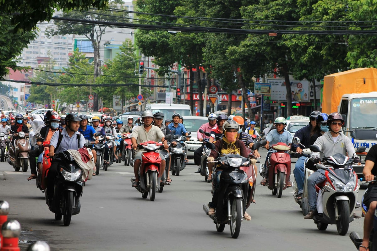 Dense motorbike traffic filling a Vietnamese city intersection