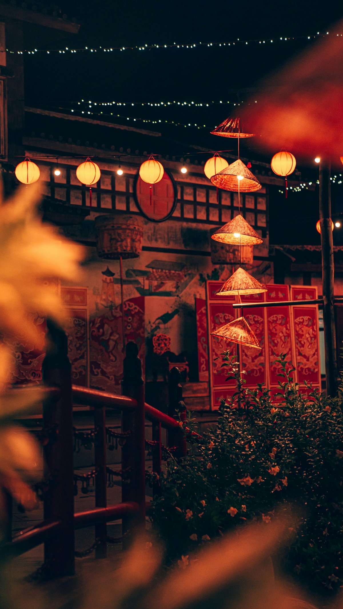 Red and gold Lunar New Year decorations hanging in a Vietnamese street